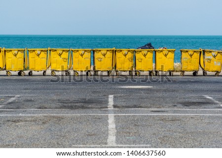 Yellow trash containers near seaside
