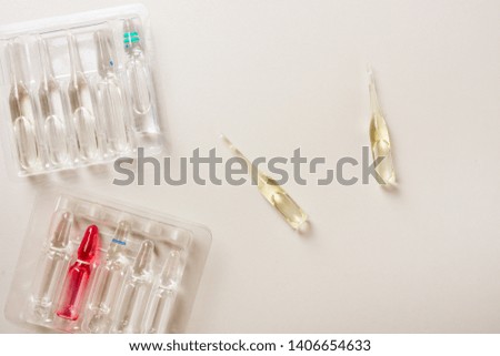 Colorful vitamin pills, capsules and medicine ampoules on an abstract background. Healthcare, medical and pharmaceutical flatlay concept. Detailed close up studio shot with copy space. Toned