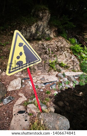 sign warning of danger. Rock slide area