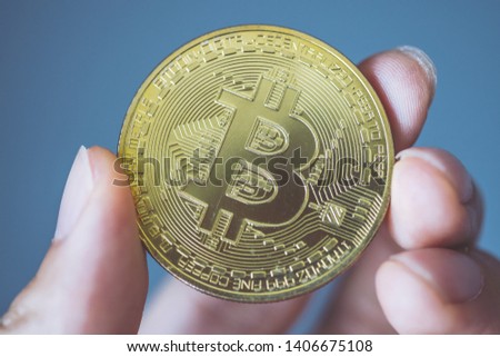 Close-up of person's hand with bitcoin