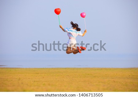 Girls with colorful balloons and happy with nature,Happy child girl playing with balloons outdoor,