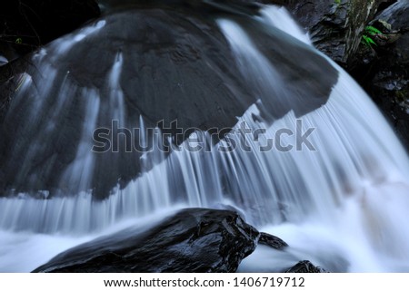 Stream waterfalls flow between the rocks, creating a beautiful picture.