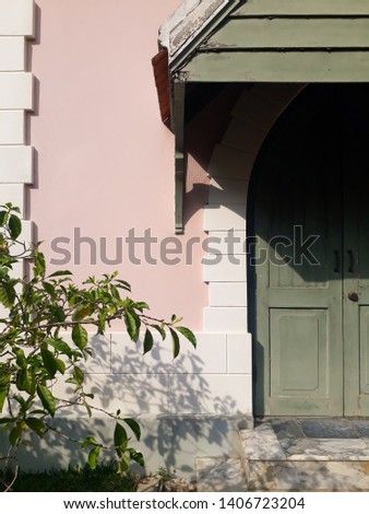 The vintage style concept of the background of the building wall with doors and trees is an element, the architecture of the building that blends perfectly with the composition of the picture and the 