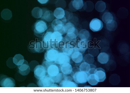 cute light blue bokeh effect of bright spots on black texture - abstract photo background
