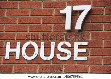 house seventeen numeral 17 on brick wall Royalty-Free Stock Photo #1406759561