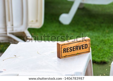 Reserved sign made from wooden plate in restaurant.Thailand