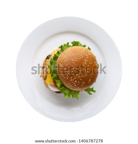 hamburger with lettuce in a plate on a white background, top view