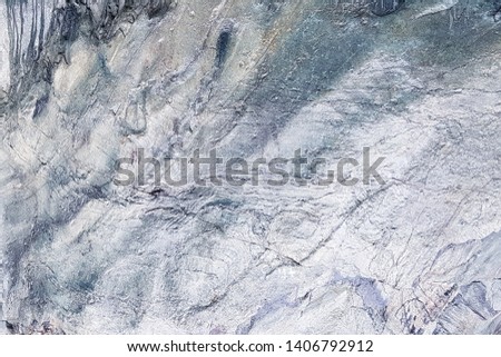 Stone background in blue metallic color with texture and contour; shoot from mobile camera in soft focus.