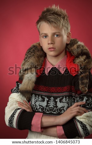 Boy teen in a sweater and shirt on a colored background