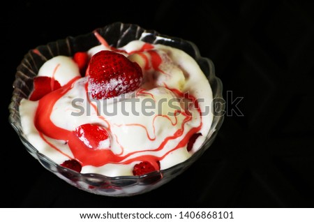 Vanilla ice-cream with strawberry on black background,summer photo,dessert