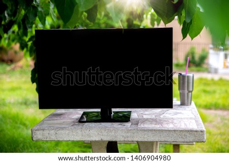 flat television on green grass in garden