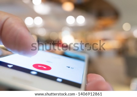 holding and pointing on decline phone call button on smartphone screen Royalty-Free Stock Photo #1406912861