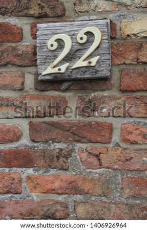 closeup of house number twenty two 22 on brink wall