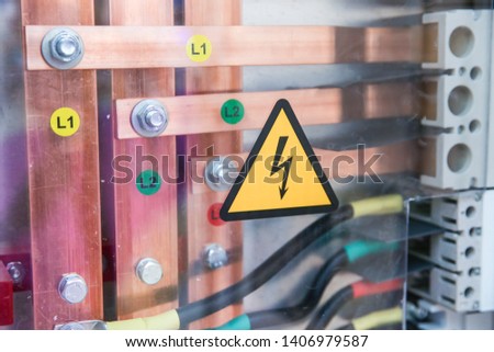 sign of electrical hazards on the transparent cover of the electric panel