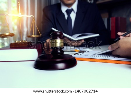 Concepts of law. Lawyer and attorney having team meeting sitting at the table in office.