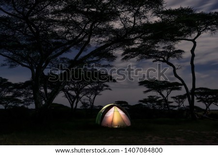 The tent lit up in the savannah