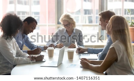 Diverse business partners sign two contracts at group meeting, businessman and businesswoman deal parties write signature on papers after successful negotiation make partnership agreement with client Royalty-Free Stock Photo #1407116351