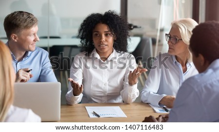 African american businesswoman talking to clients make business offer explain deal benefit convince diverse partners at group negotiation meeting, mixed race manager consult customers sell services Royalty-Free Stock Photo #1407116483
