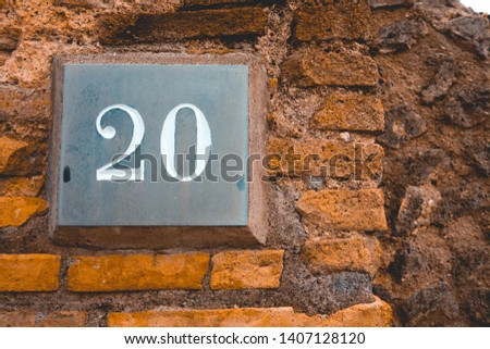 handmade sign of number 20 on brown background