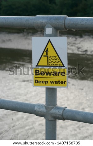 Beware Deep Water warning sign on a metal fence