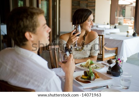 A young couple having dinner at a restaurant Royalty-Free Stock Photo #14071963