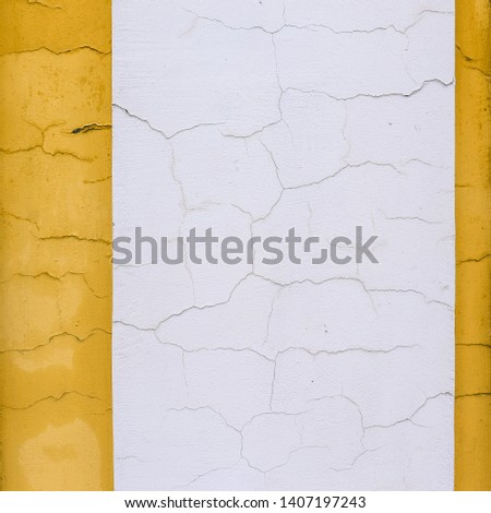 Cracks on the white and yellow wall. Geometric color blocks and lines. Interior Design. Blank background, space for text.