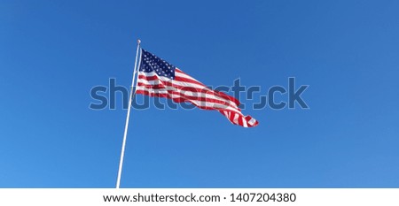 the American flag flying in the sky