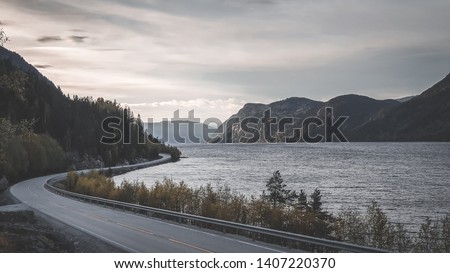 Landscape Picture, road in mountains, Norway. Beautiful sunset or sunrise in Viking land. Yellow road markings, family trip in summer, beautiful Norway. Mountains rivers and lakes