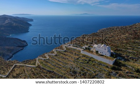 Aerial drone photo of picturesque uphill church of Panagia (Virgin Mary) with stunning views to chora of Folegandros island and deep blue Aegean sea at sunset, Cyclades, Greece