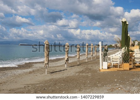 Closed sunshades on  the beach of Kalamata, in spring. Peloponnese, Greece, South-east Europe.