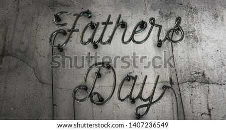 Fathers day neon sign that has had its electric turned off on a concrete grunge wall.