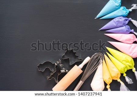 Flat lay. Variety of colors of royal icing in plastic piping bags.