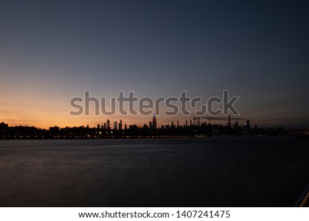 The New York City skyline at sunset as seen from Domino Park, Brooklyn.
