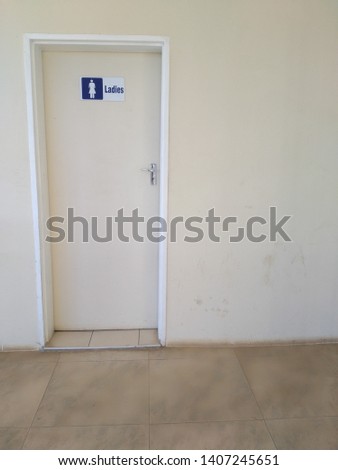 A ladies toilet door with a toilet door sign that shows that it is for ladies only. A door that leads into the ladies lavatory.