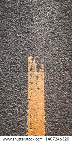 Close up  picture of a yellow line. road texture, road markings. Europe Norway England. Vertical picture. Traffic .
