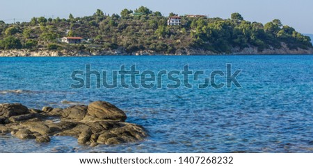 picturesque panorama of Mediterranean sea in south Greece coast line stone beach waterfront scenery landscape photography with island background and cottage renting apartment for spend vacation time 