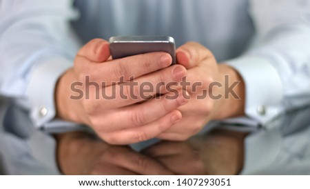 Man holding smartphone in hands closeup reading news, modern technology, app