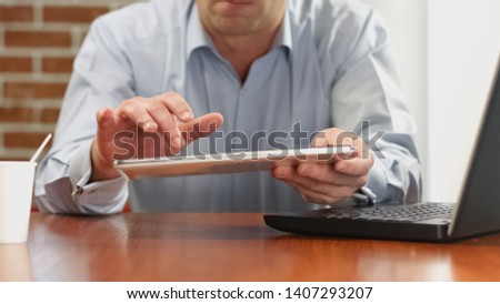Businessman working tablet sitting in cafe, scrolling photos, modern technology