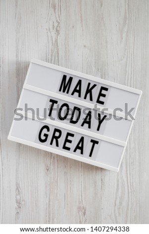 Lightbox with 'Make today great' words on a white wooden surface, top view. Overhead, from above. Flat lay. 