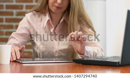 Businesswoman watching presentation on tablet, modern technology, office work