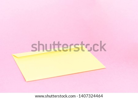 Beauty yellow envelope; branding mock up; front view on pastel pink background.