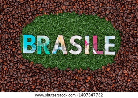 Close up of Brasile word made from colorful letters on artificial grass surrounded by roasted coffee beans
