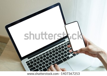 mockup image screen computer,cell phone with blank space for text,using laptop contact business searching information in workplace on desk in office.design creative work space on wooden desktop