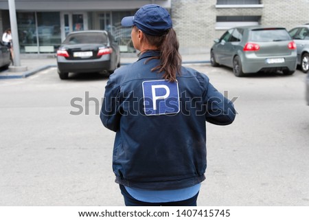 The girl in the form of a parking attendant in the city