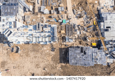 drone image of urban area under construction. building machinery working at construction site