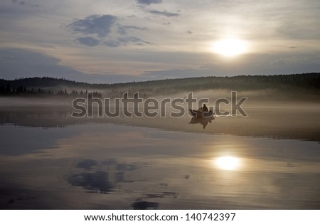  two men in a boat fishing on a calm lake at sunset