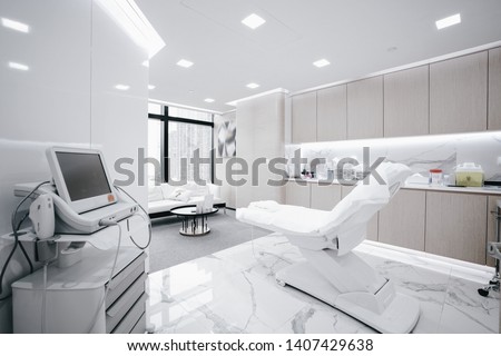 Hospital interior with operating surgery table, lamps and ultra modern devices, technology in modern clinic. Royalty-Free Stock Photo #1407429638