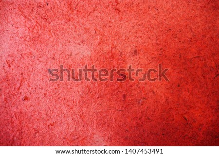 Closeup of red mulberry paper in dark red color with texture and rough surface for background and decoration with handmade craft. Cool banner on page, ad, presentation and website