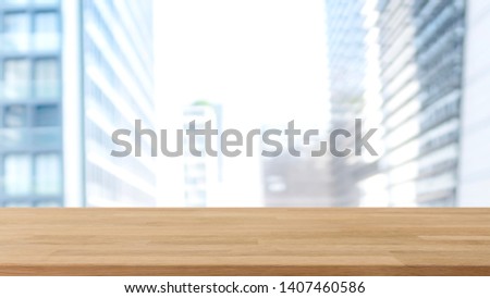 Empty wood table top and blur glass window wall building banner mock up background - can used for display or montage your products.