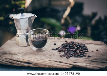 Coffee beans, Moka Pot, Coffee cup on old wood plank in the garden